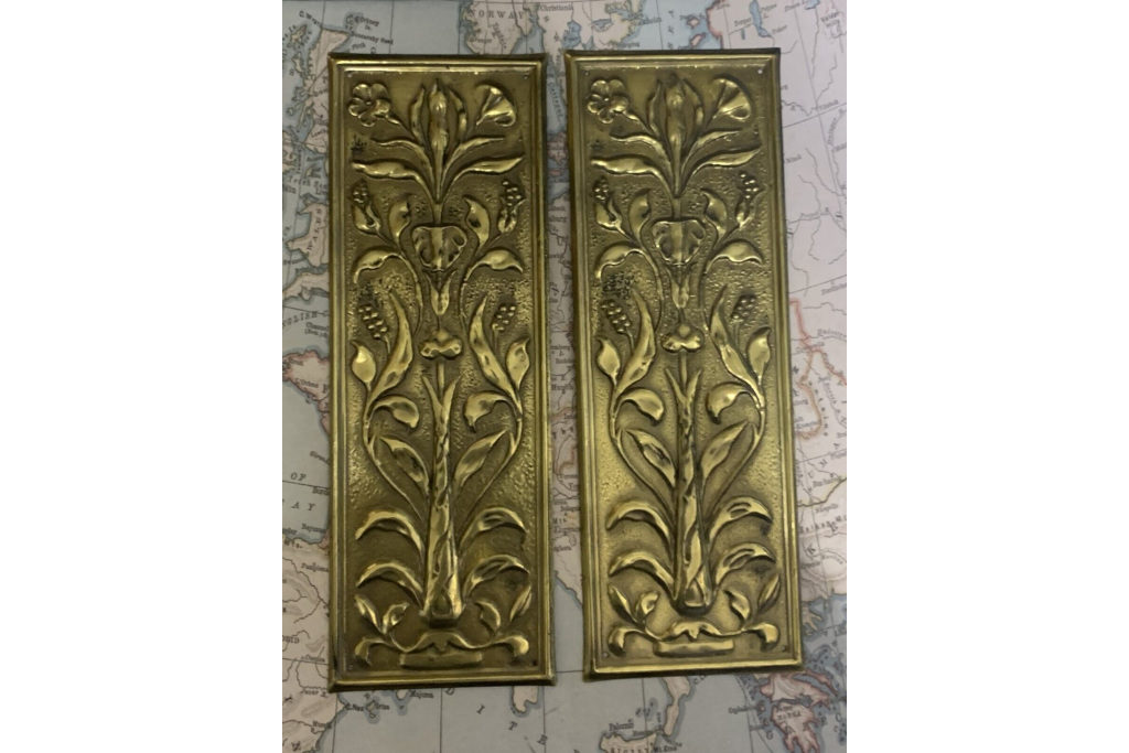 Two metal oblongs with floral pattern