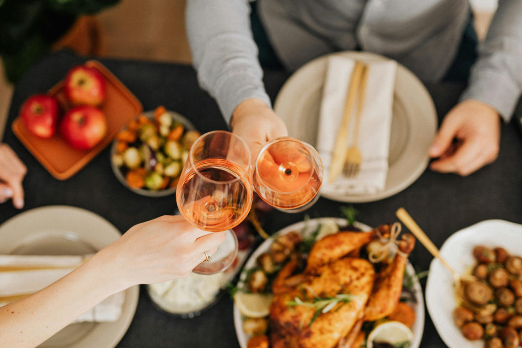 Clinking glasses over Christmas dinner
