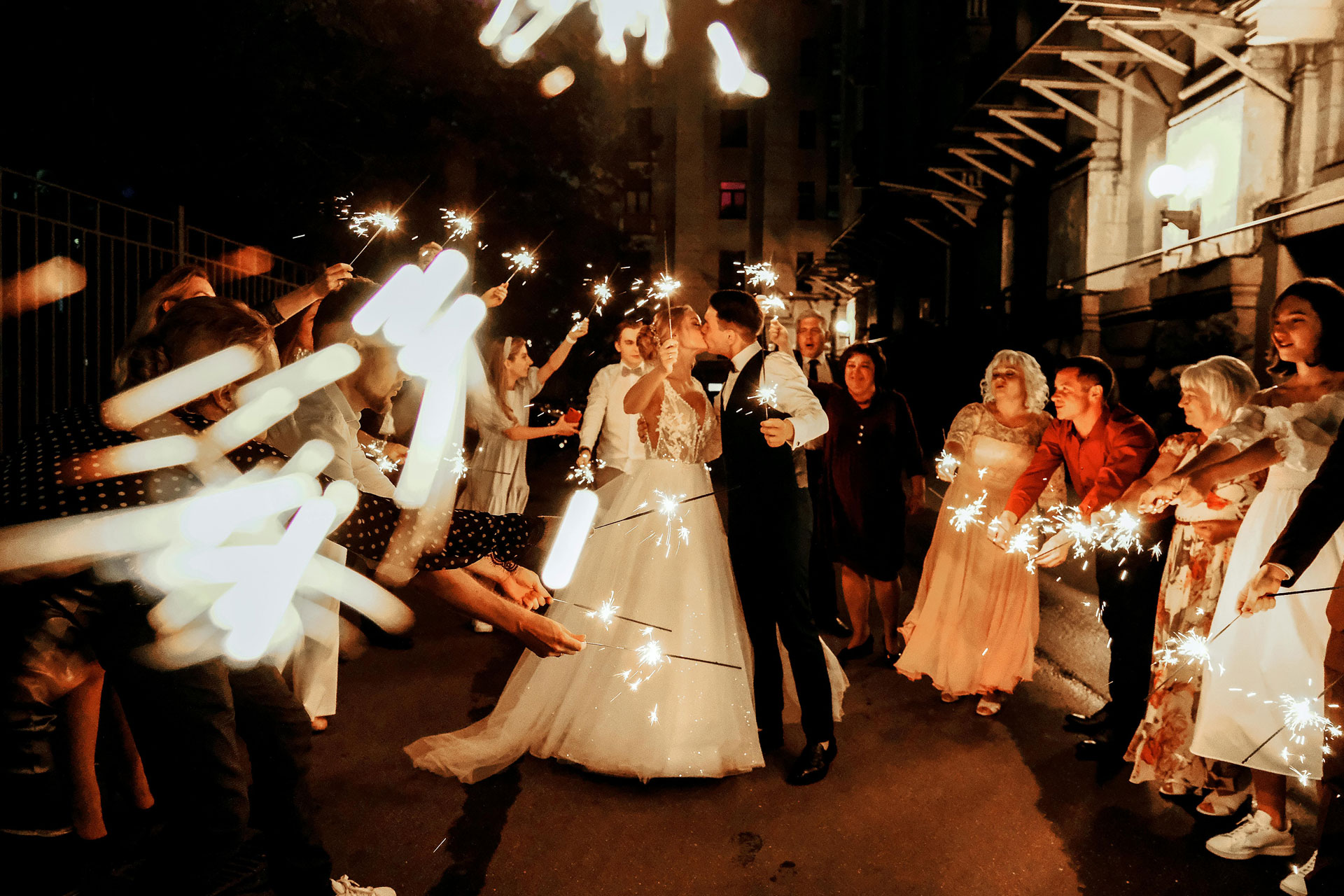 Bride and groom leaving their wedding with sparklers