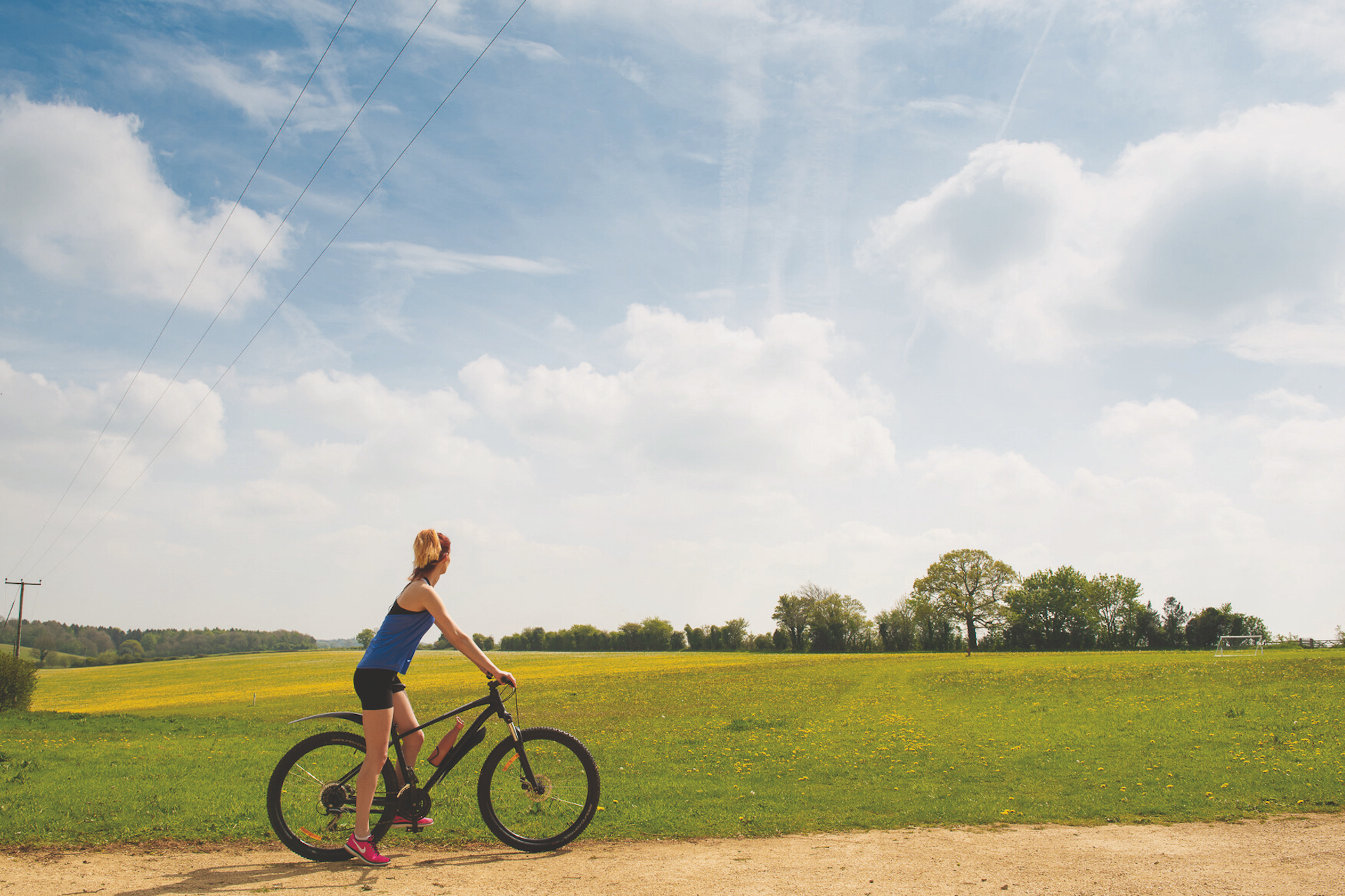 pob hotels woman cycling in front of field