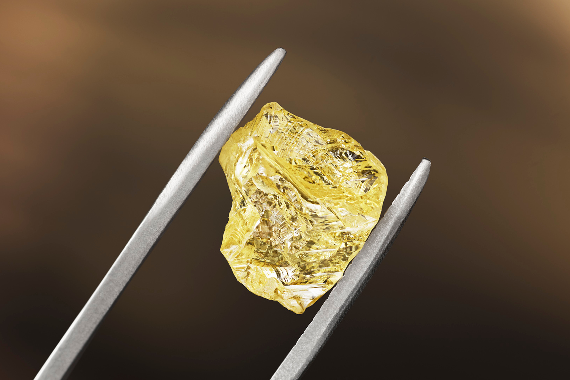 A diamond held in tweezers