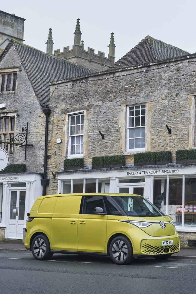 The Volkswagen ID. Buzz Cargo in front of a tea room