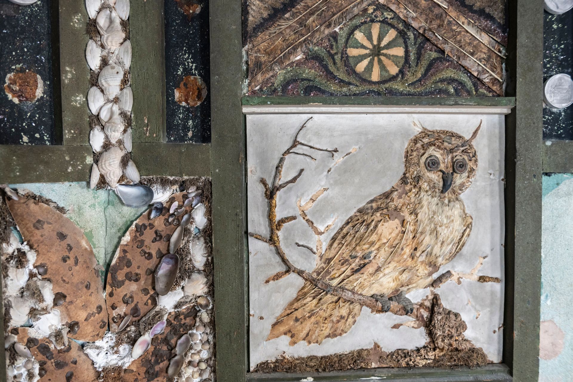Close-up shot of the La Ronde shell gallery, with an owl engraving