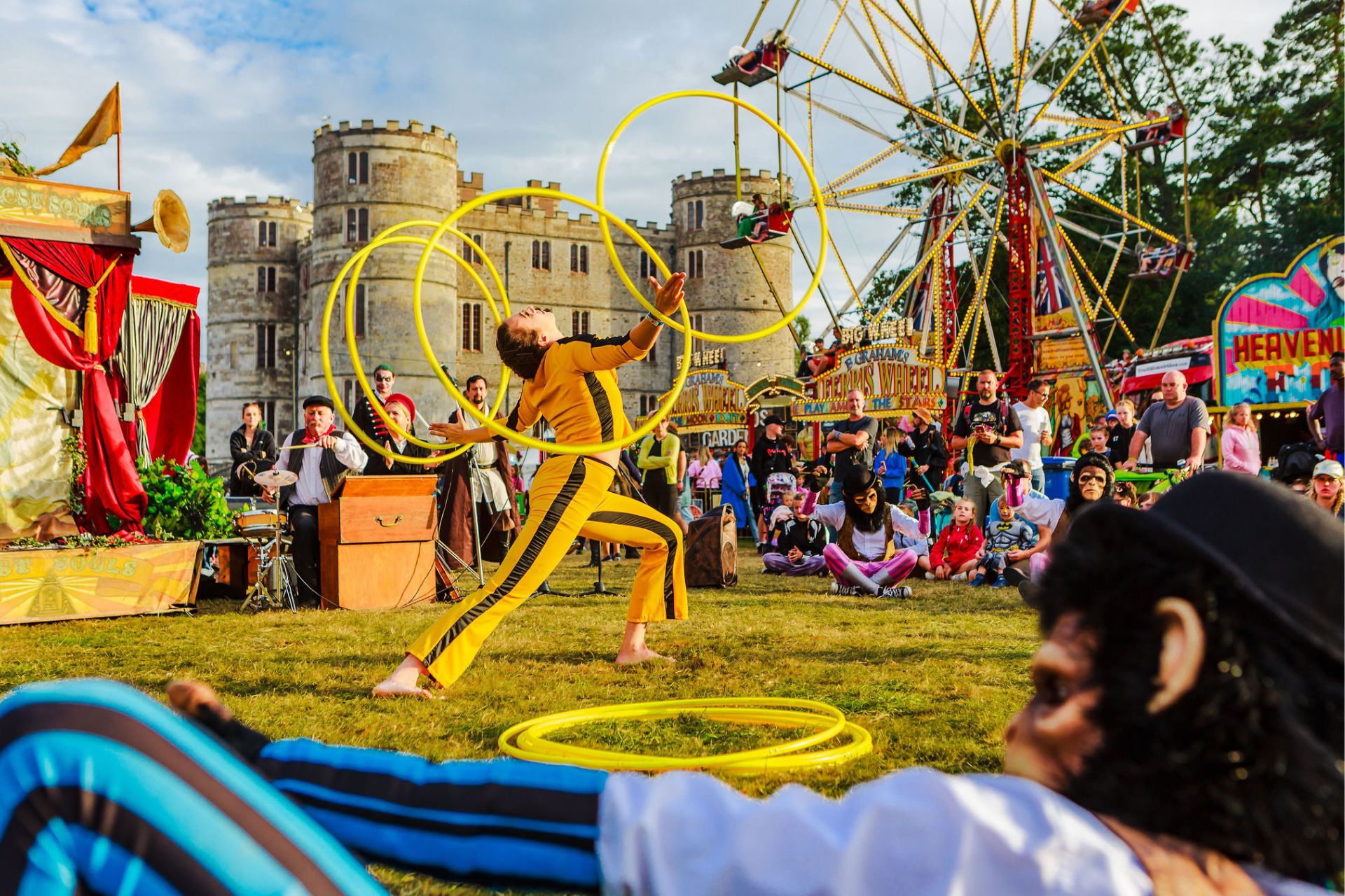 Circus performers in the castle grounds at Camp Bestival