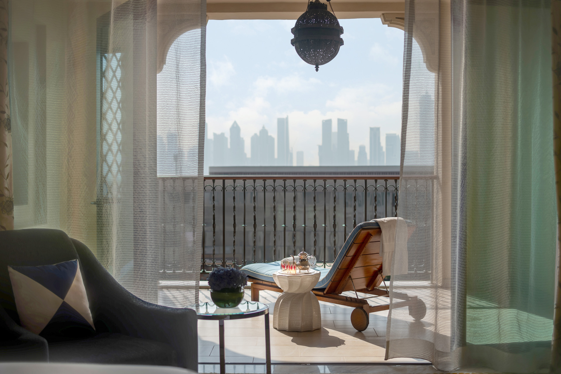 A lounger on a balcony overlooking Dubai