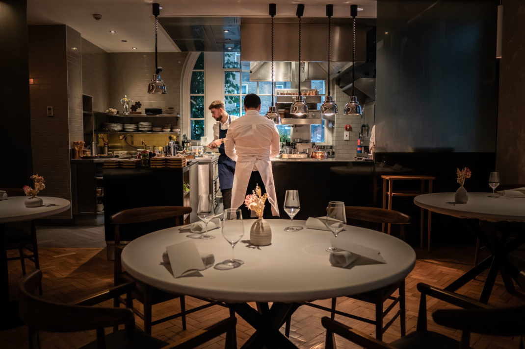 Chef Rafael Cagali standing by the kitchen in Da Terra