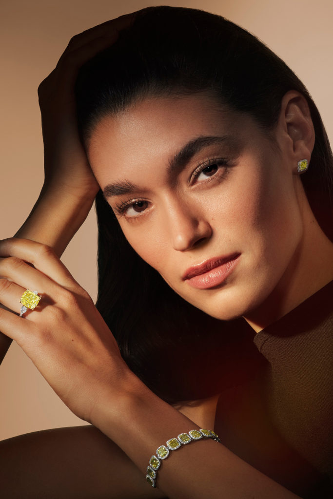 Woman wearing De Beers diamond jewellery