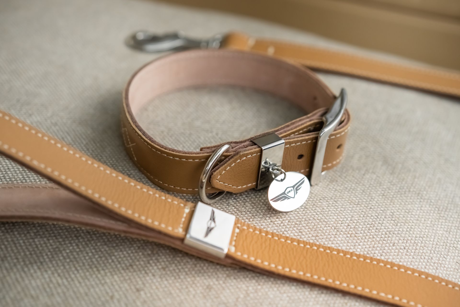 Tan leather dog collar and lead with Genesis branding