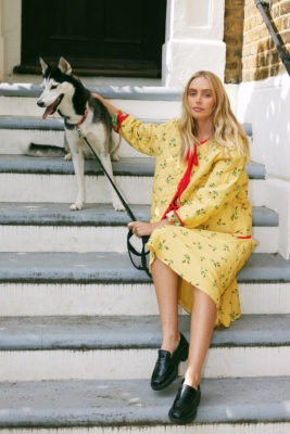Woman sat on steps with dog