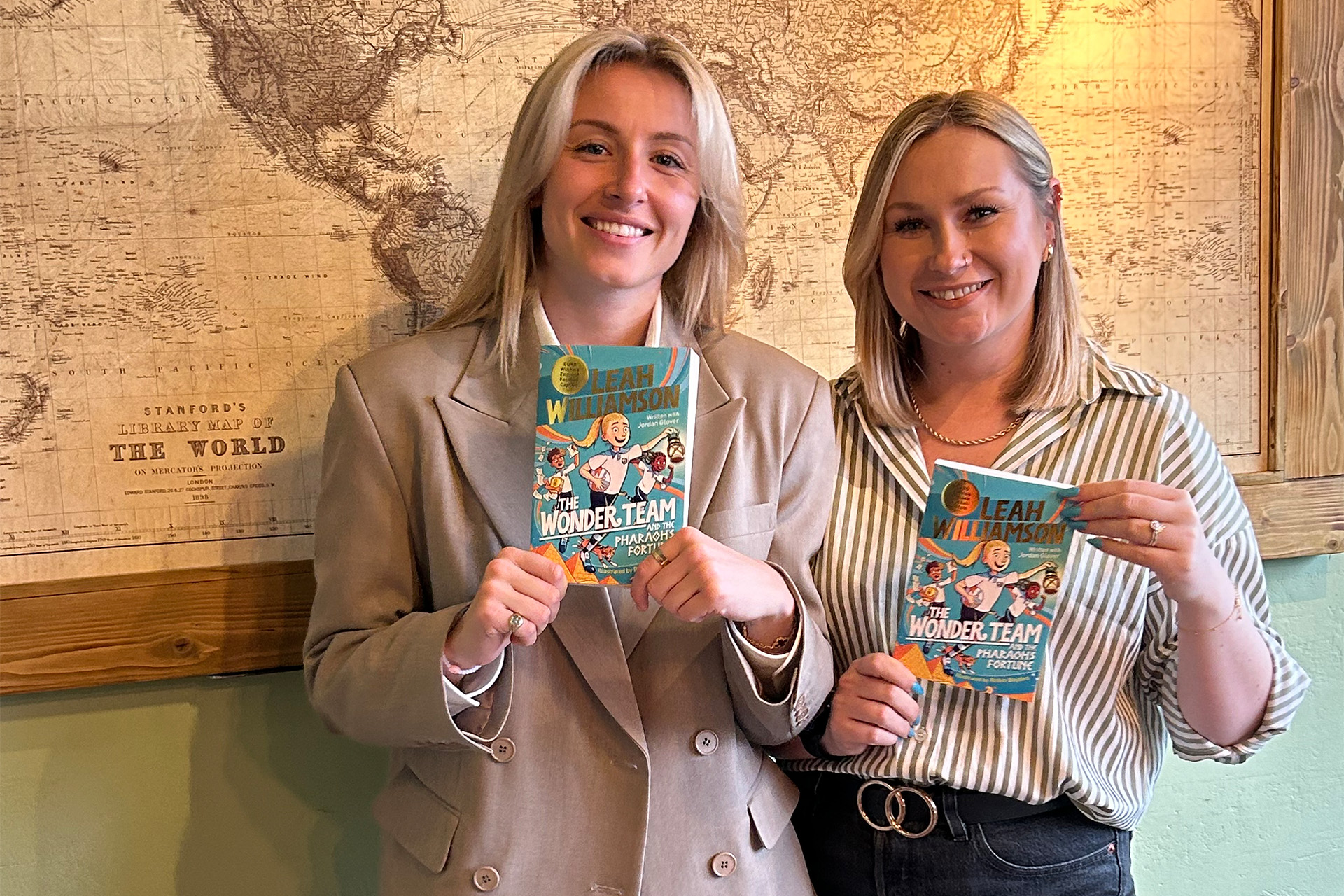 Leah Williamson and Jordan Glover on publication day holding the new book