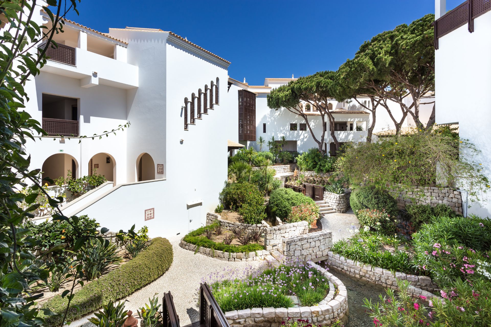 Apartments at Pine Cliffs Resort, with a leafy courtyard in the middle.