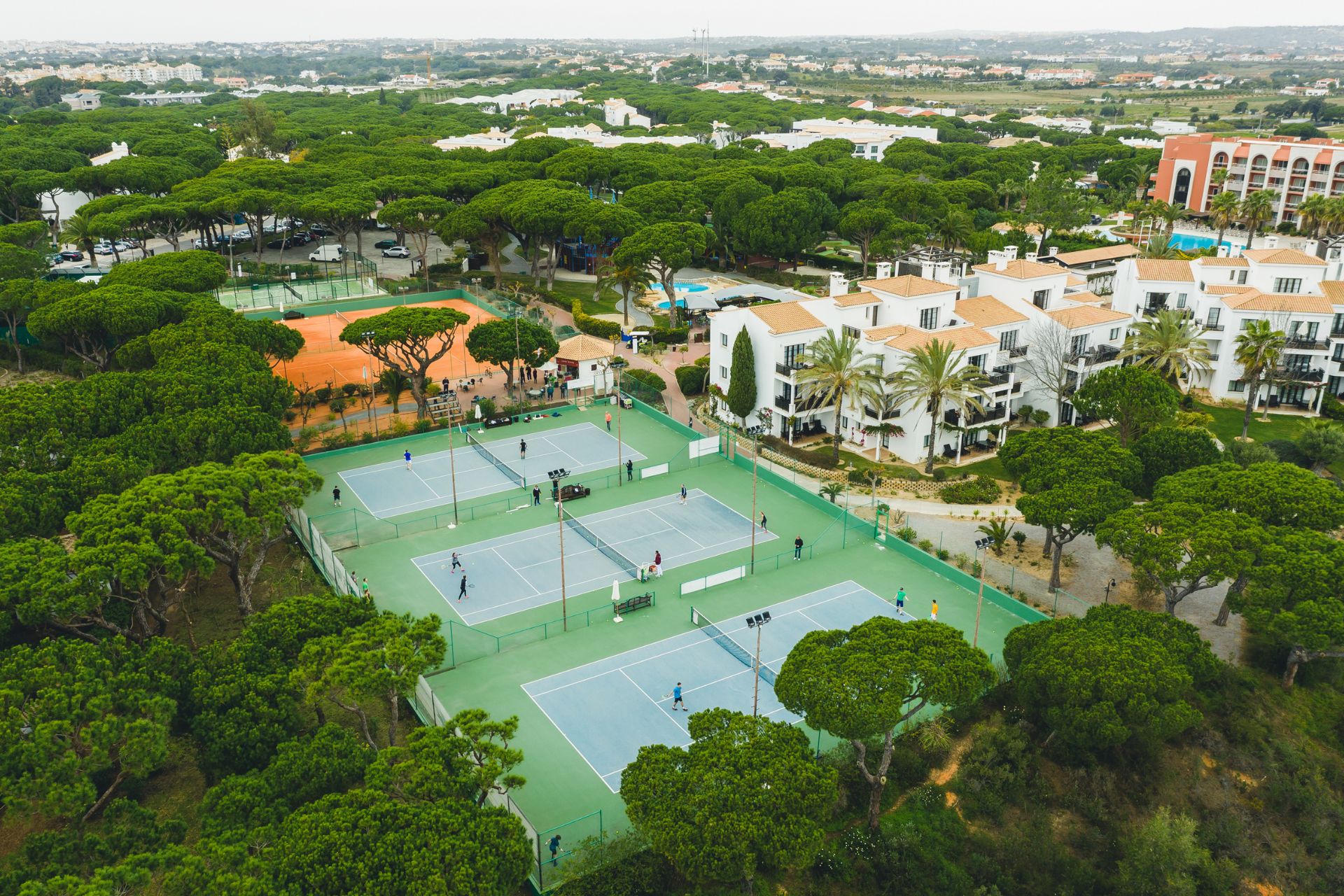 Aerial view of the Annabel Croft Tennis Academy with tree-lined tennis courts.