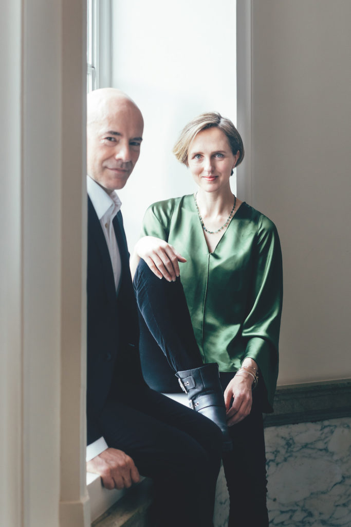 Portrait of Tamara Harvey and Daniel Evans, man and woman sitting in windowsill