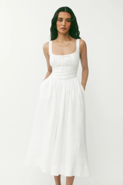 Woman in white milkmaid dress
