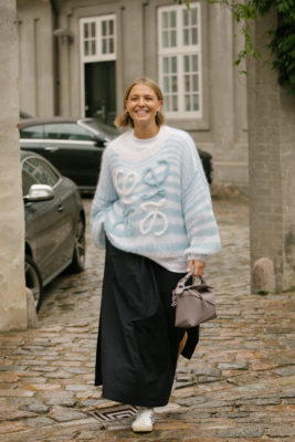Woman with 90s bob and blue jumper