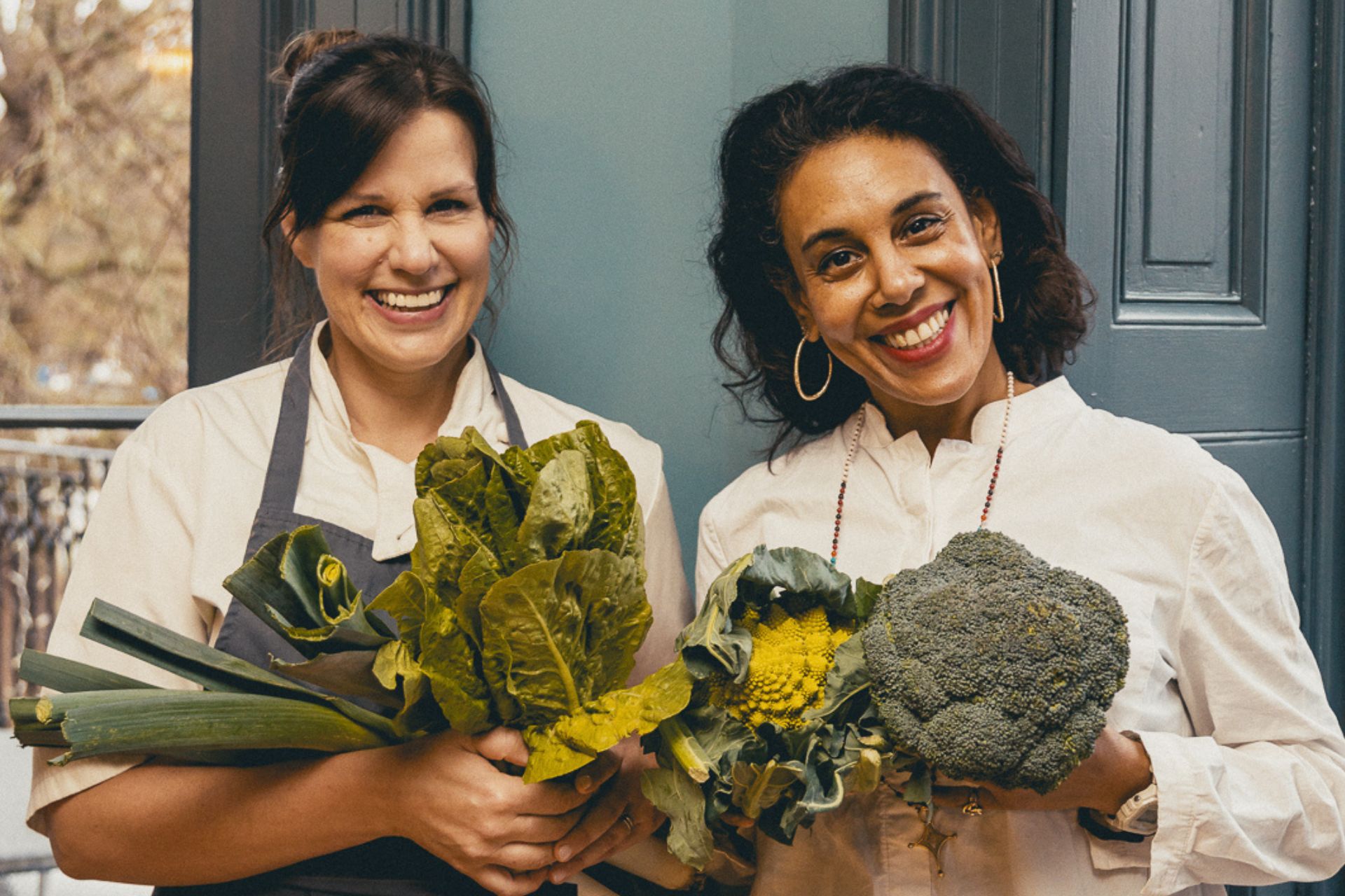Vanessa Marx and Samantha Trinder, co-owner of Bingham Riverhouse, both holding fresh vegetables.