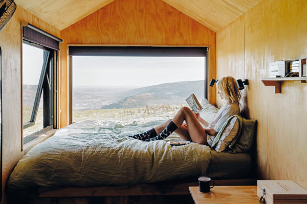 Women sat on the bed in Goose Cabin