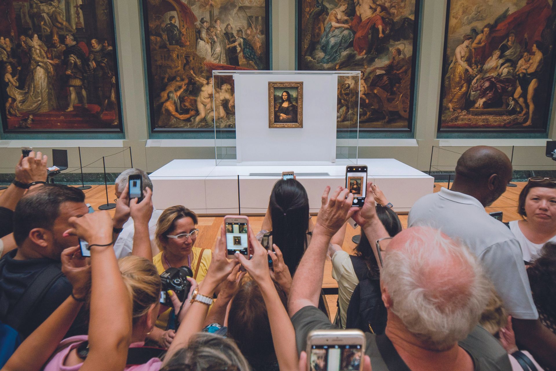 Crowds of tourists taking pictures of the Mona Lisa