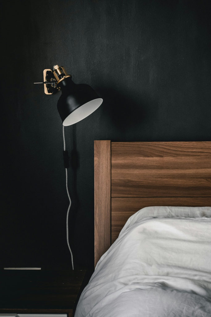 A bedroom with black walls