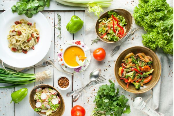 Aerial view of vegetarian food on a white wooden table