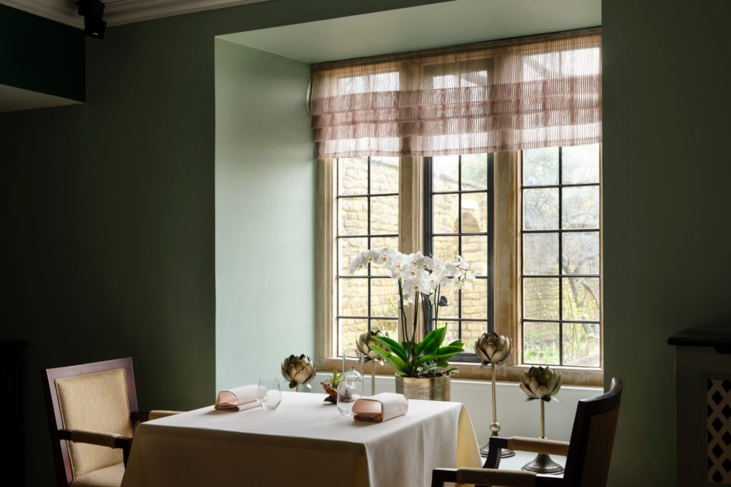 Dining room with white tablecloth and pale green walls