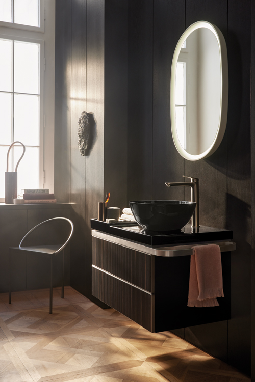 A black vanity in a dark bathroom