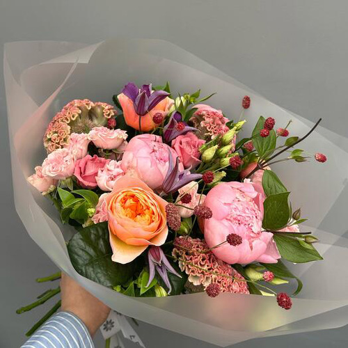 A hand holding a bouquet of flowers