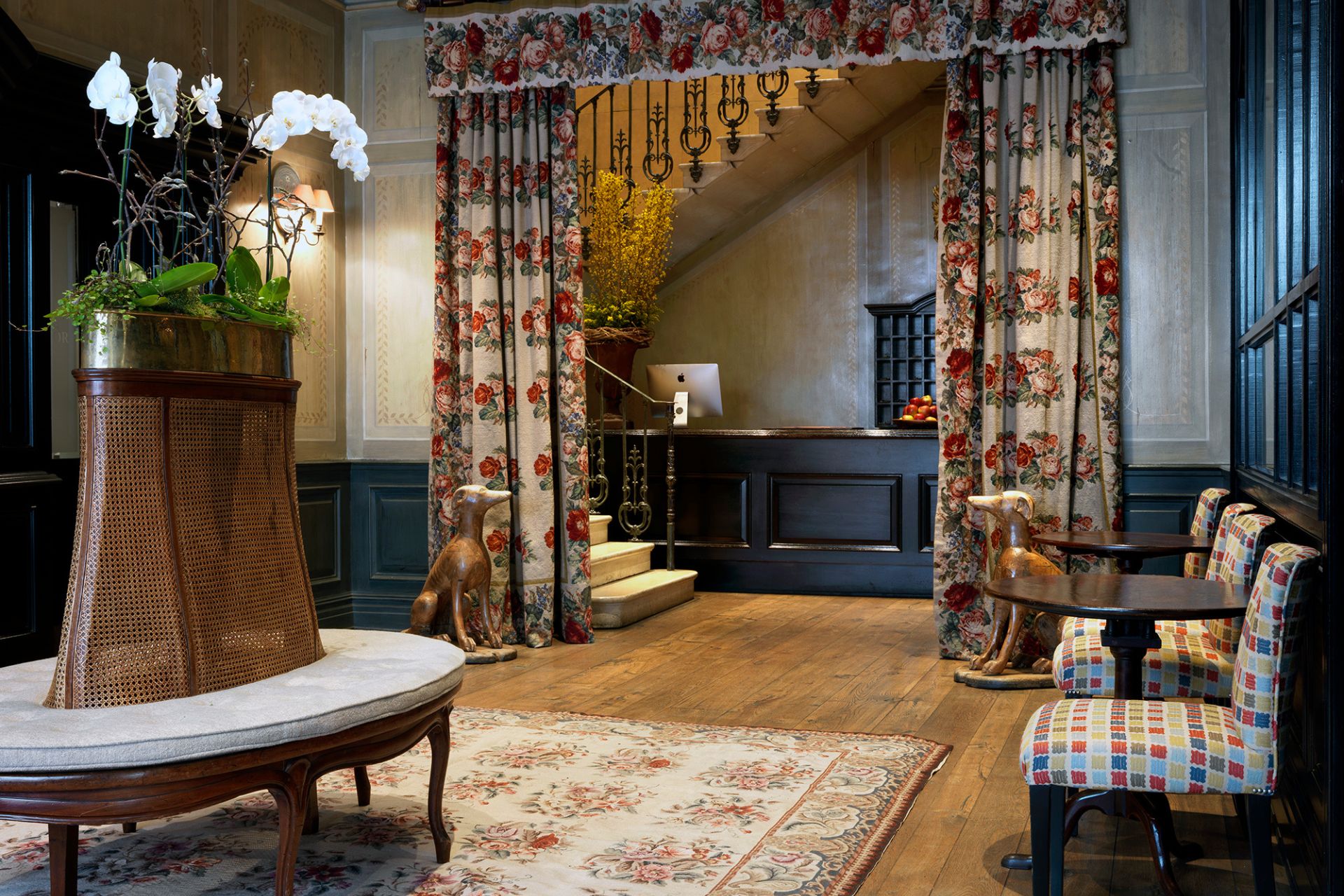 Covent Garden Hotel lobby, with bold print curtains, armchairs and a rug.