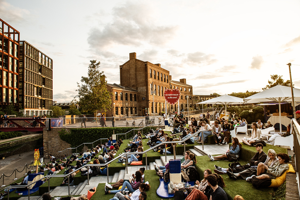 People gathered outside watching a film