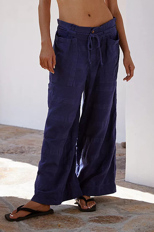 A woman wearing dark blue trousers