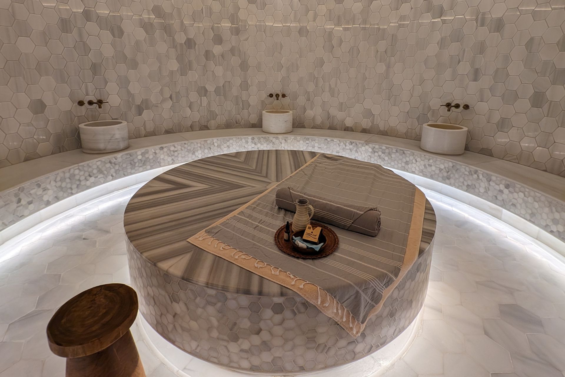 Spa with raised marble table in the centre.