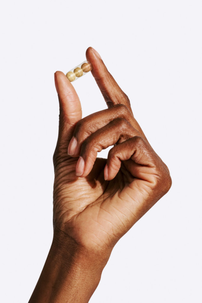 Hand holding pill
