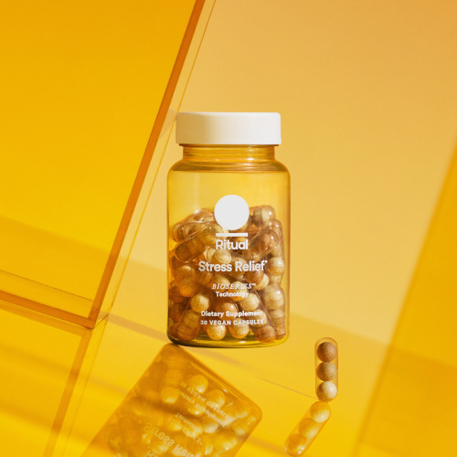 Yellow background with bottle of supplements by US wellness brand Ritual