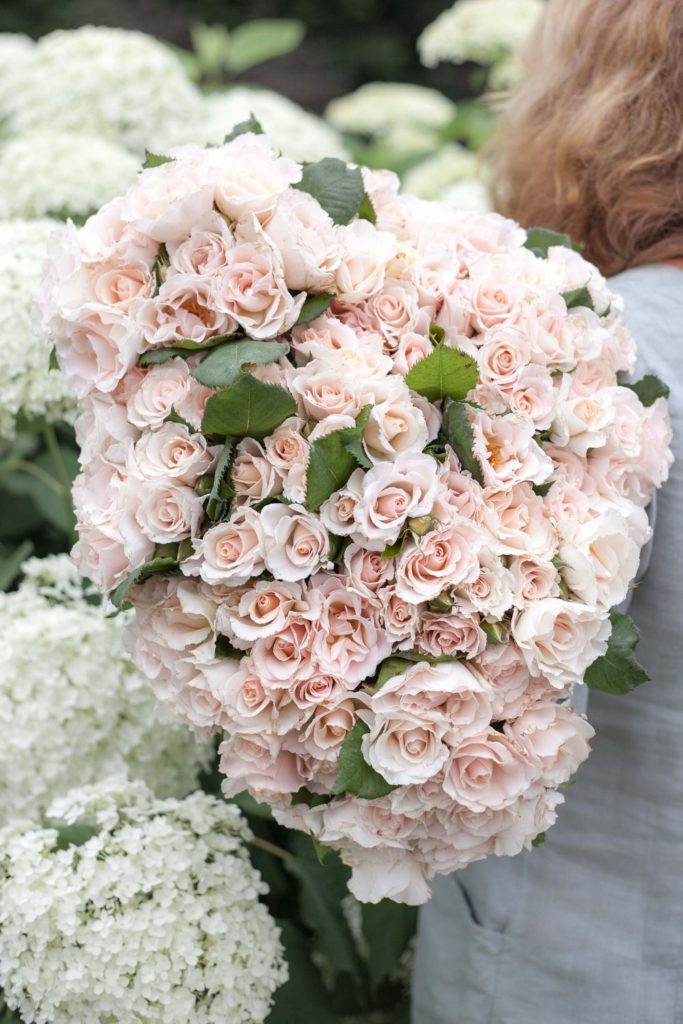 Rosebie Morton holding a bouquet of pink roses.