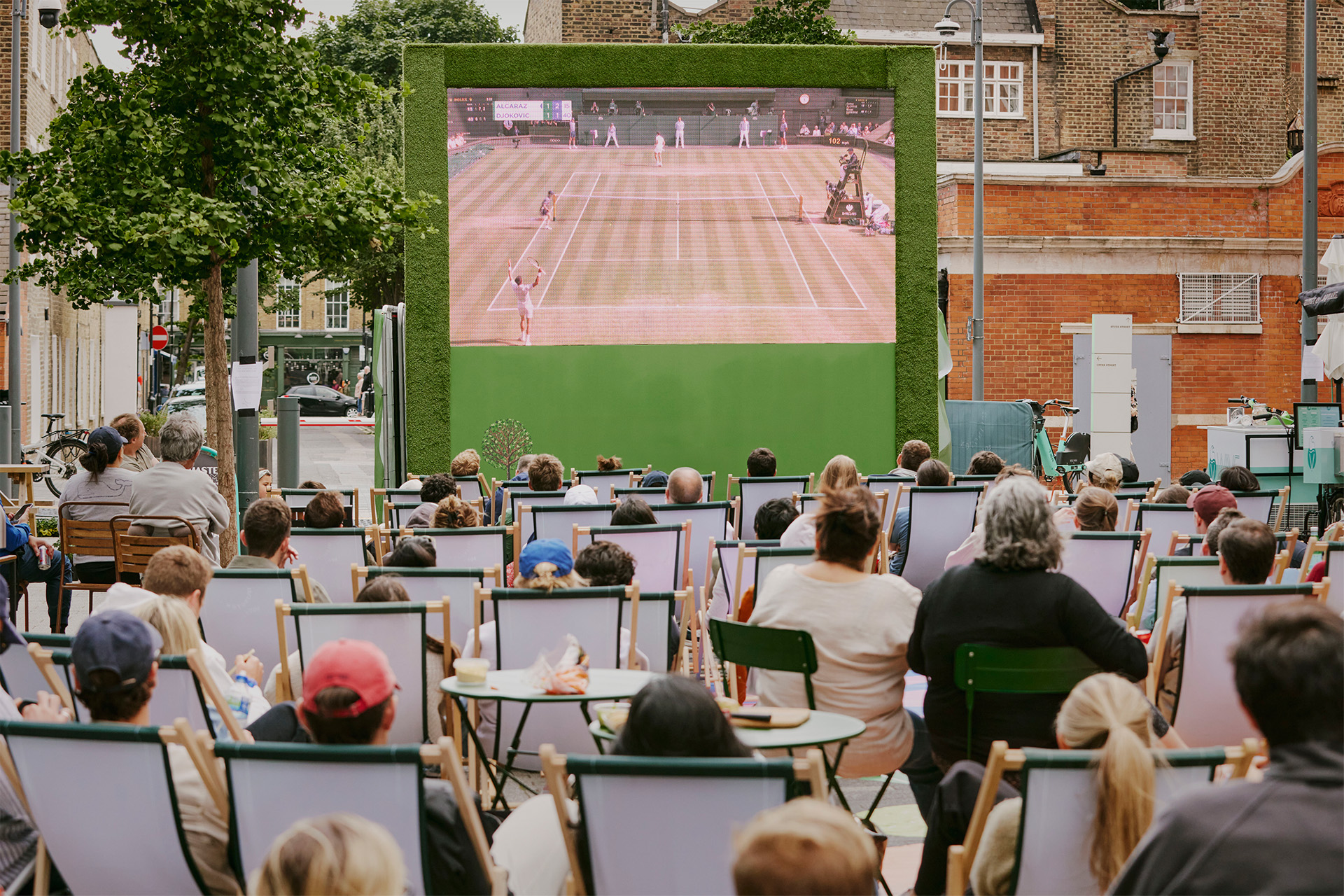 People watching Wimbledon on an outdoor screen in London