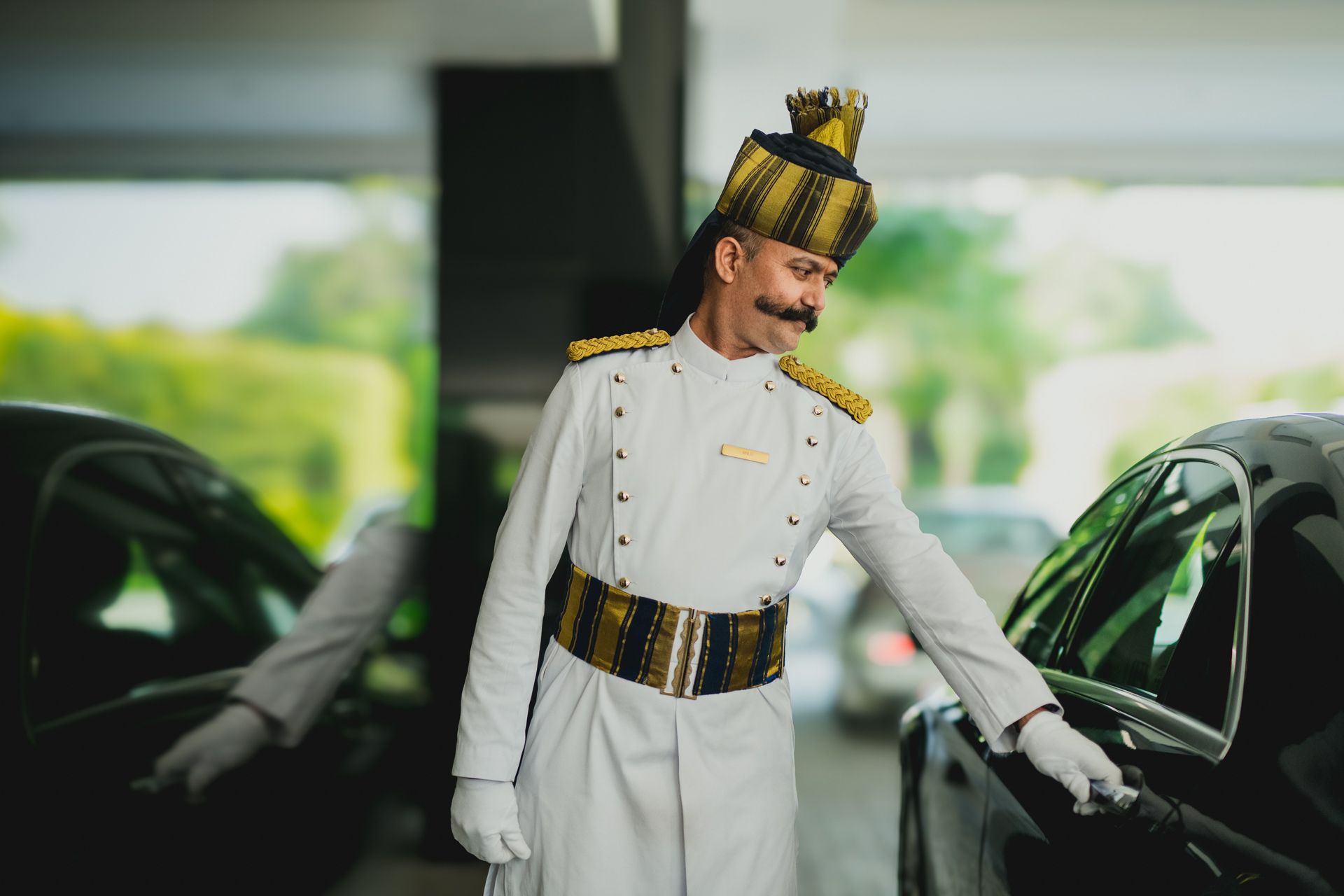 Staff at Oberoi Hotel opening a car door for a guest