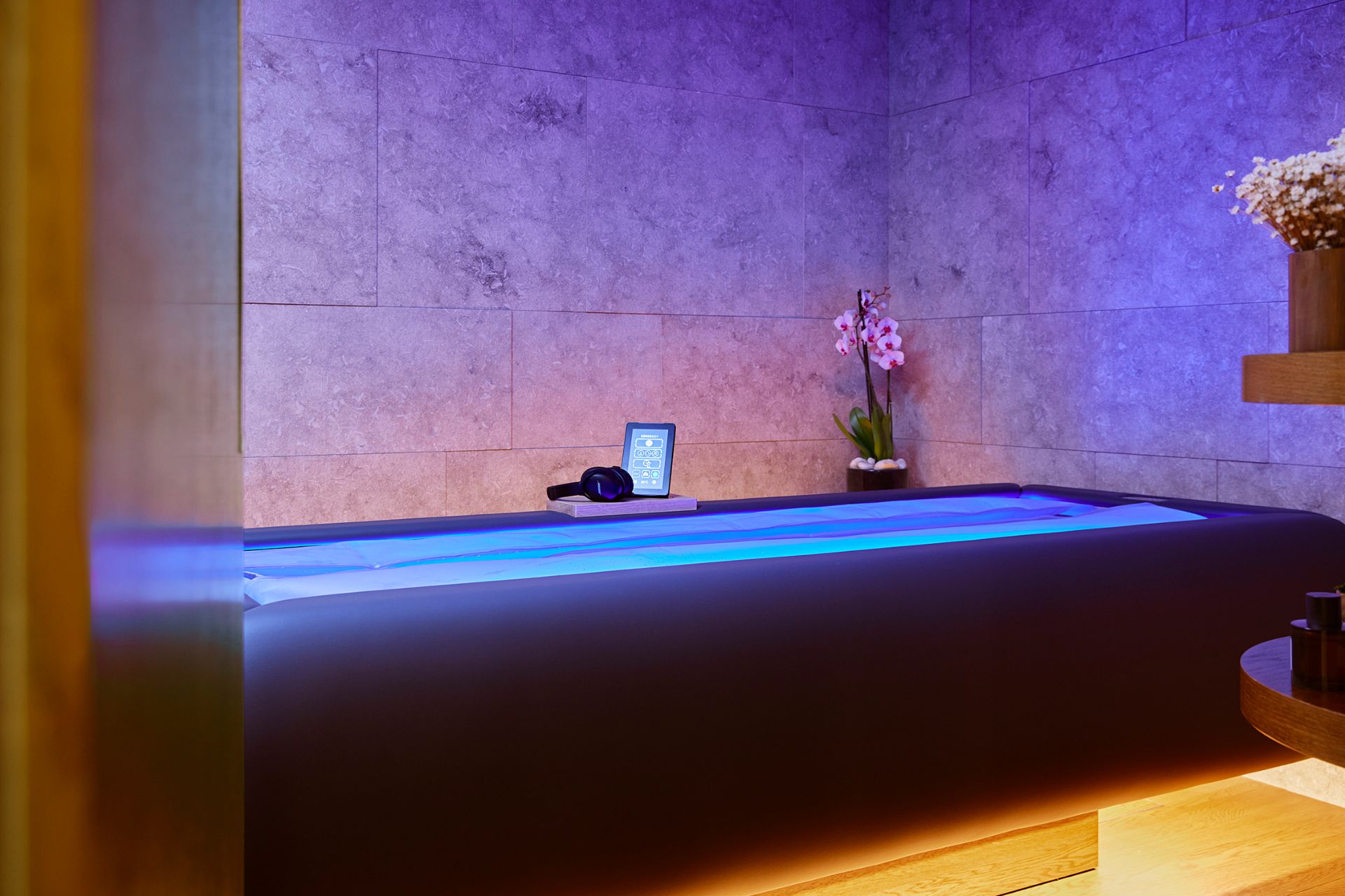 Zerobody Dry Float bed with blue LED lights in a marble treatment room