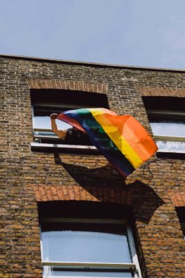 pride flag flying out a window