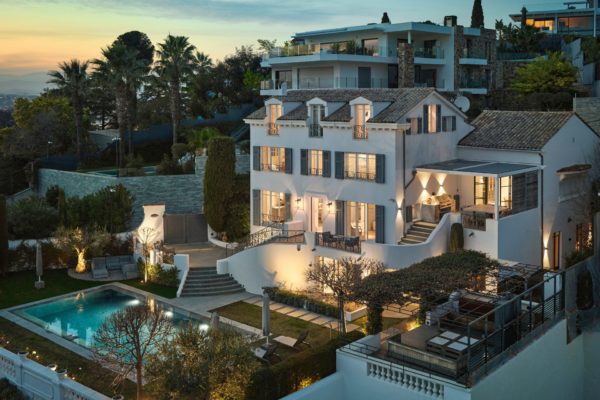 Dusk view of Cannes villa with outdoor pool