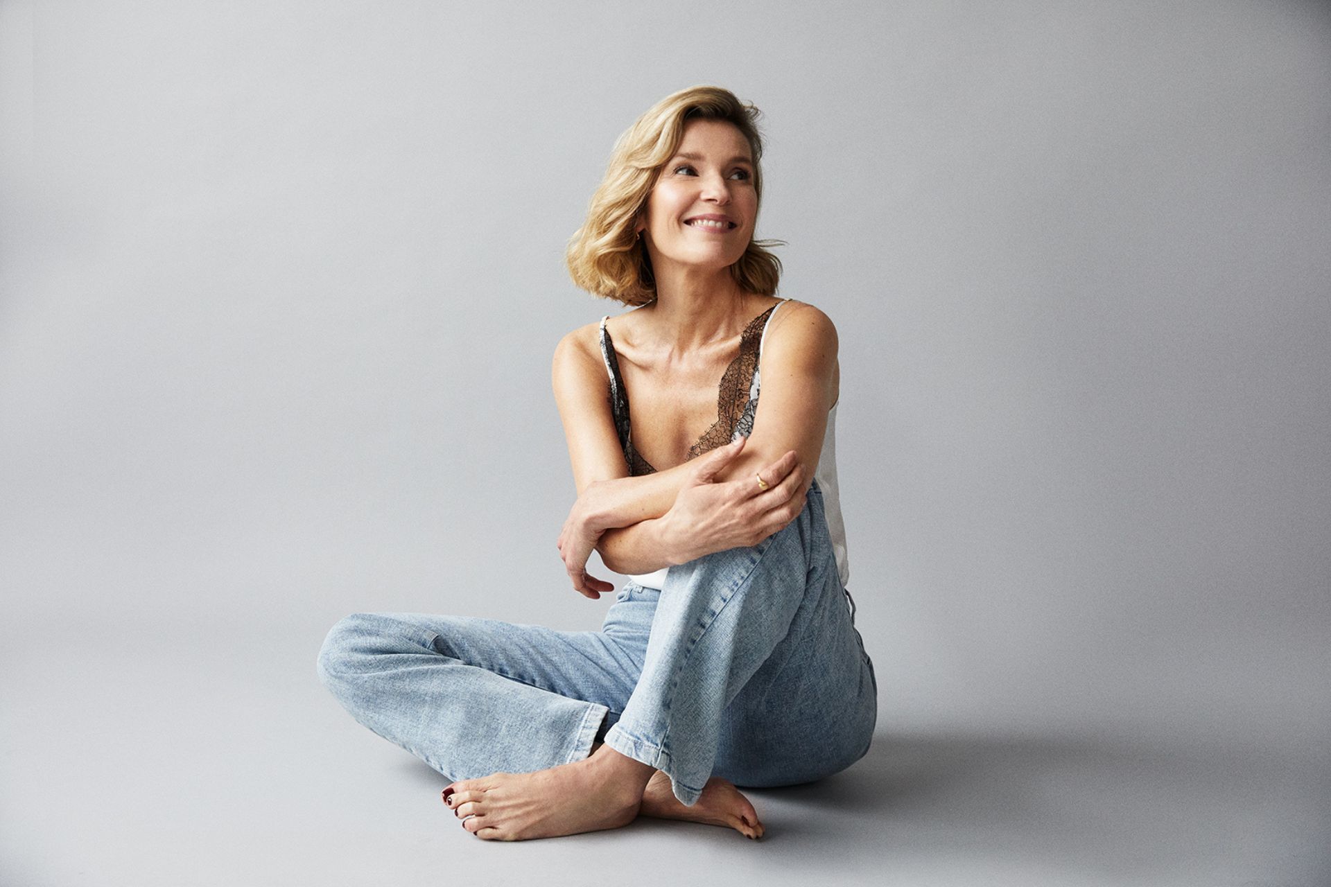 Joanna Bobin wearing blue jeans and a lacy top