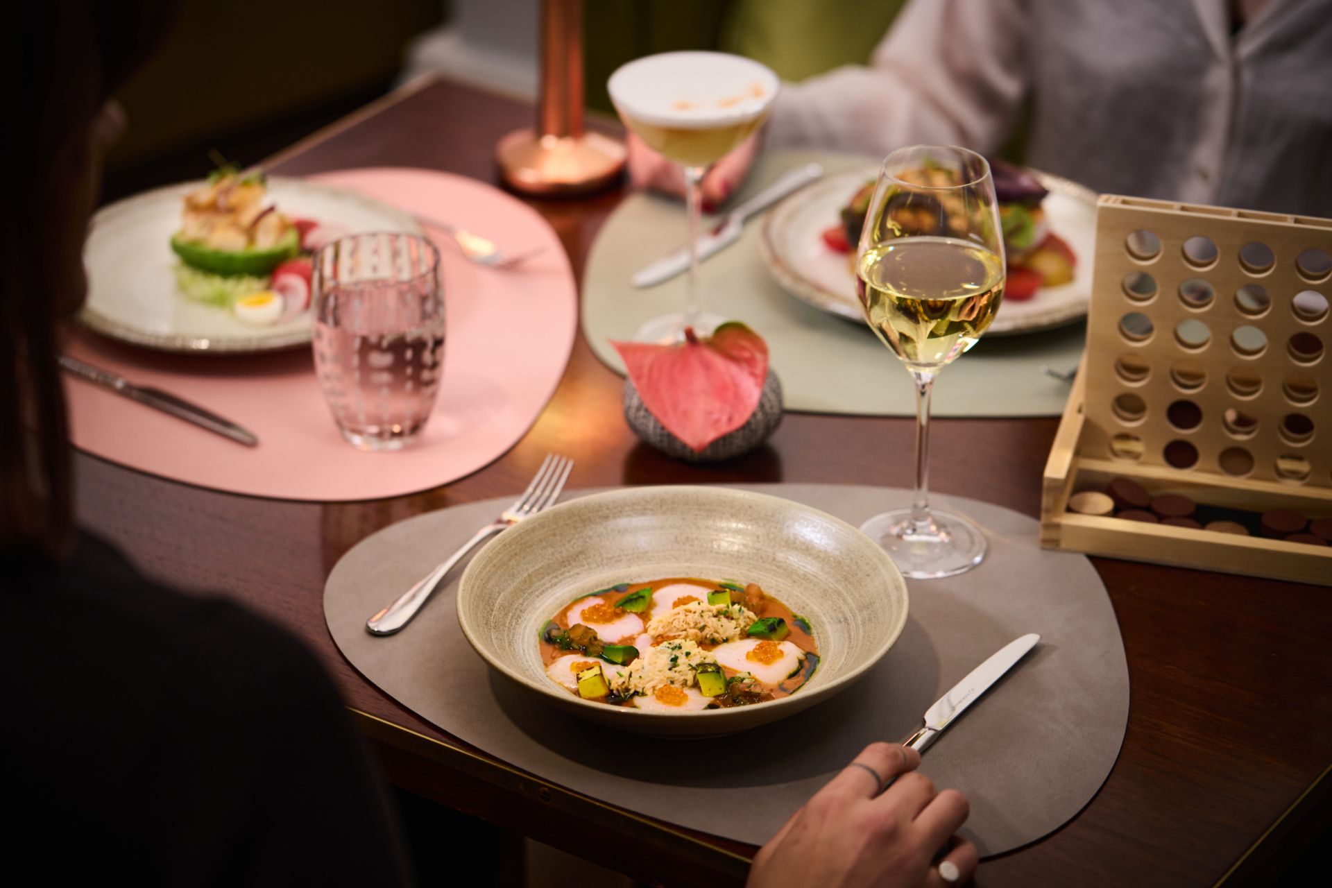 Chilean dishes served on grey and pink placemats.