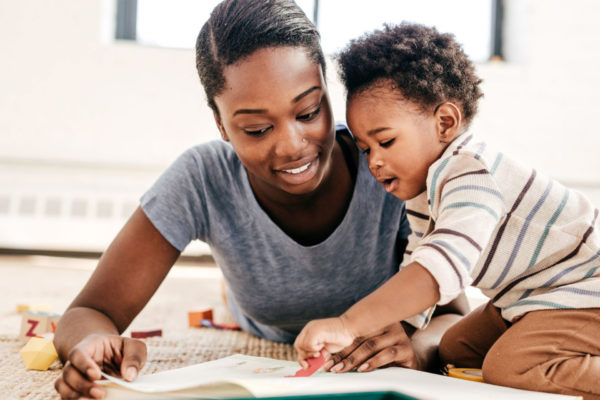 Mother and toddler reading together