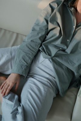 A woman in a shirt sat on a sofa