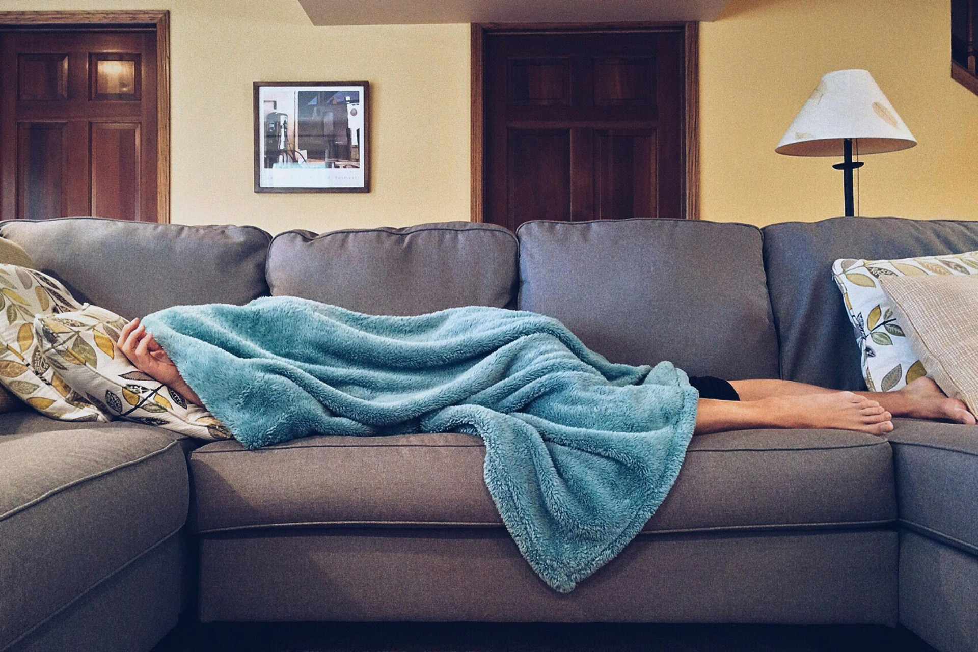 A person sleeping on a sofa