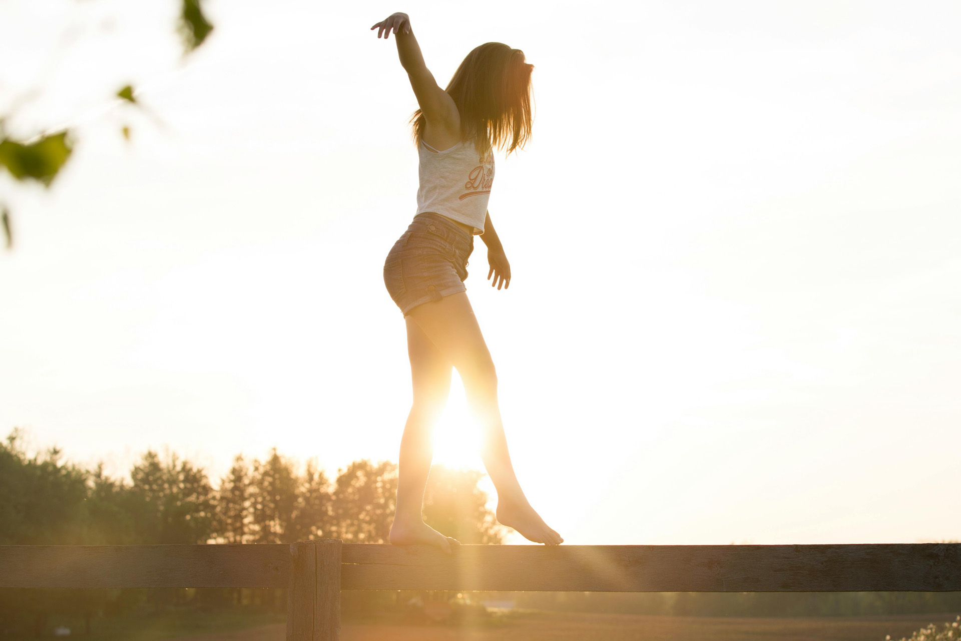 A woman balancing on a beam