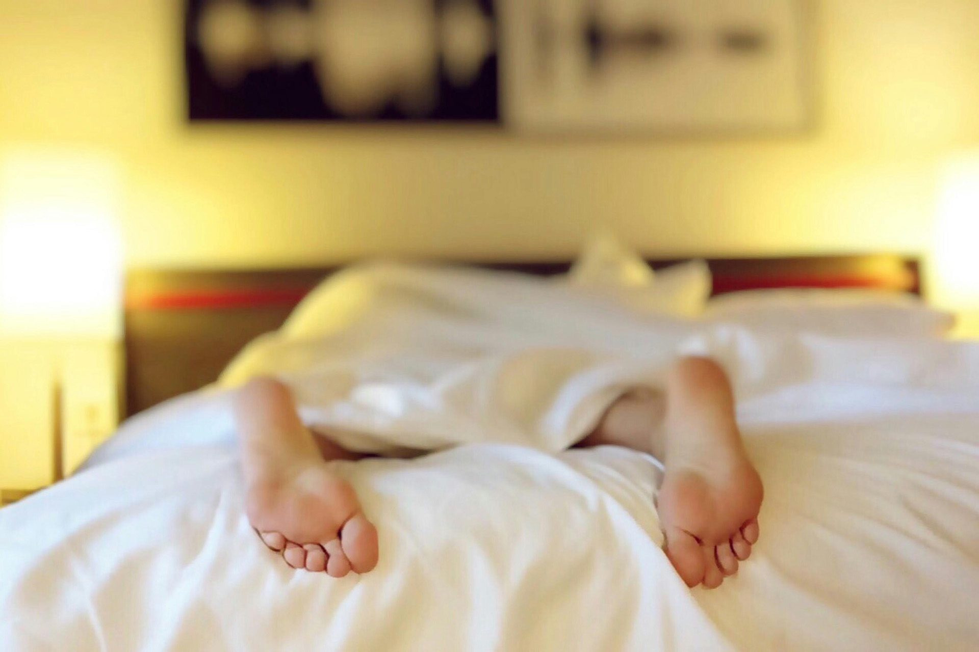 Feet poking out the end of a bed