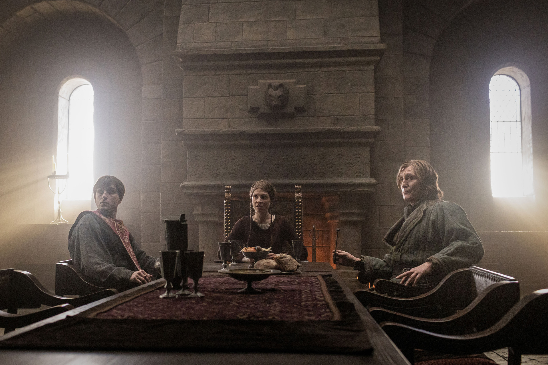 Three people gathered around a table