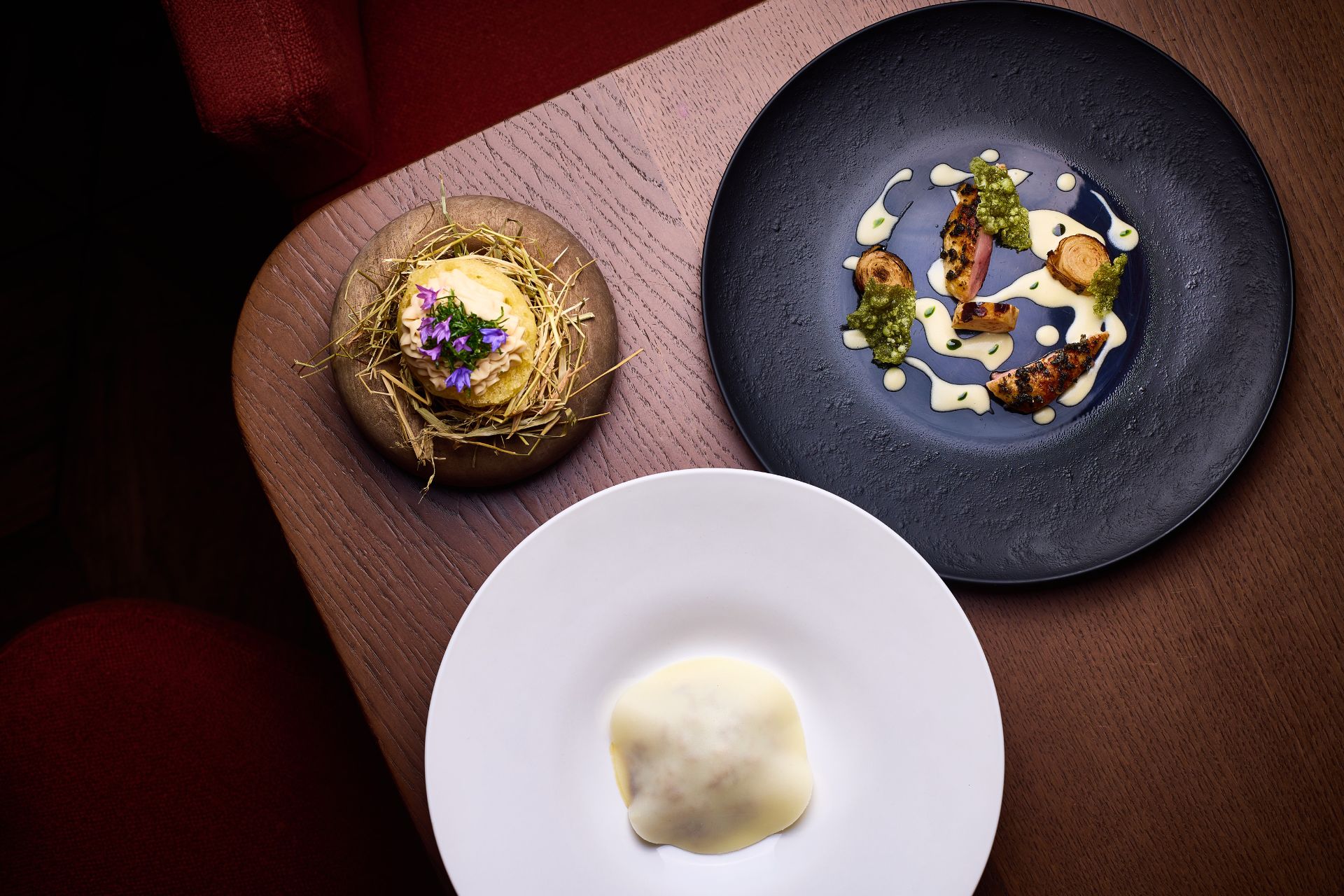 East Sussex Quail served on a black plate with edible flowers