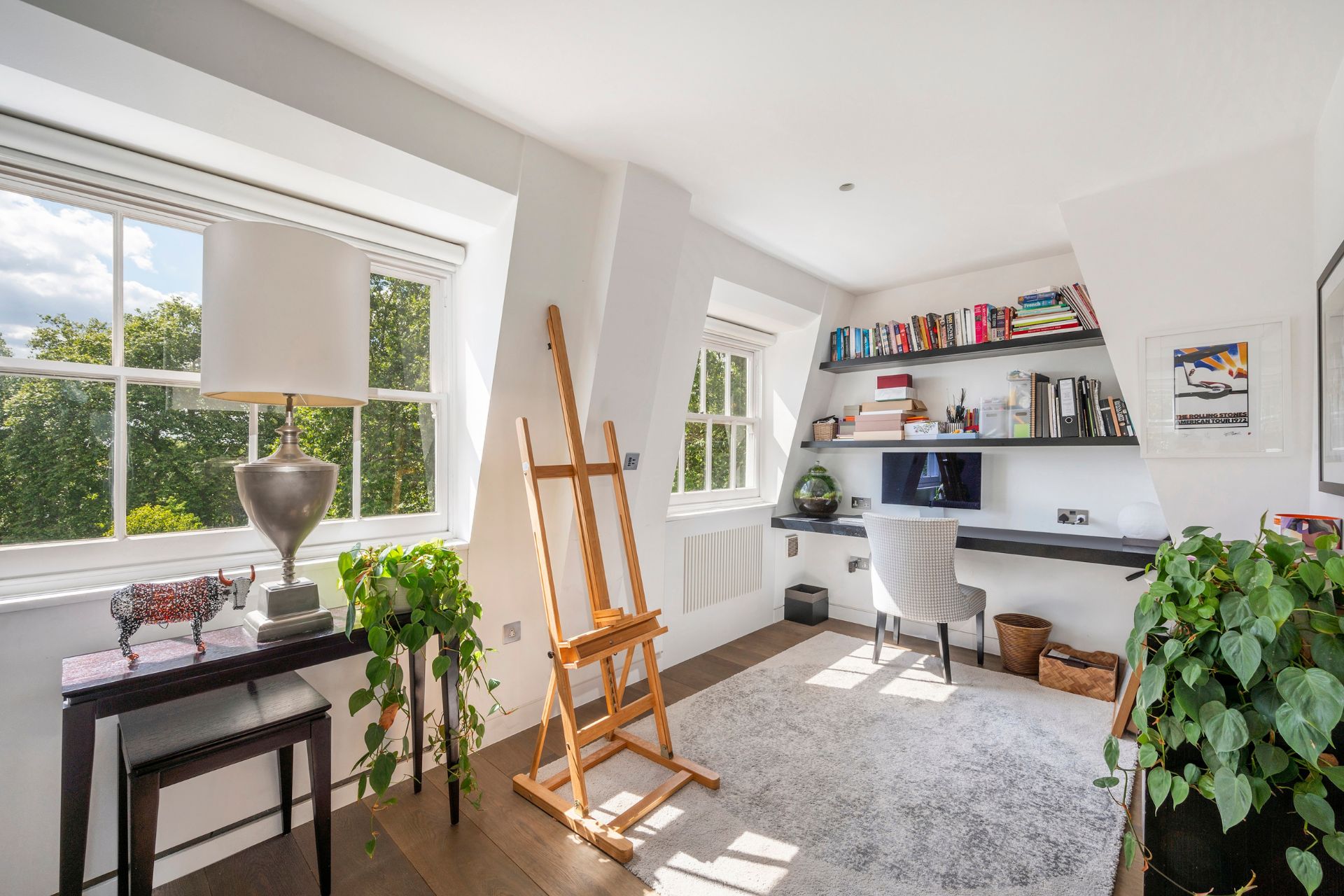 Study with easel, bookshelves and desk.