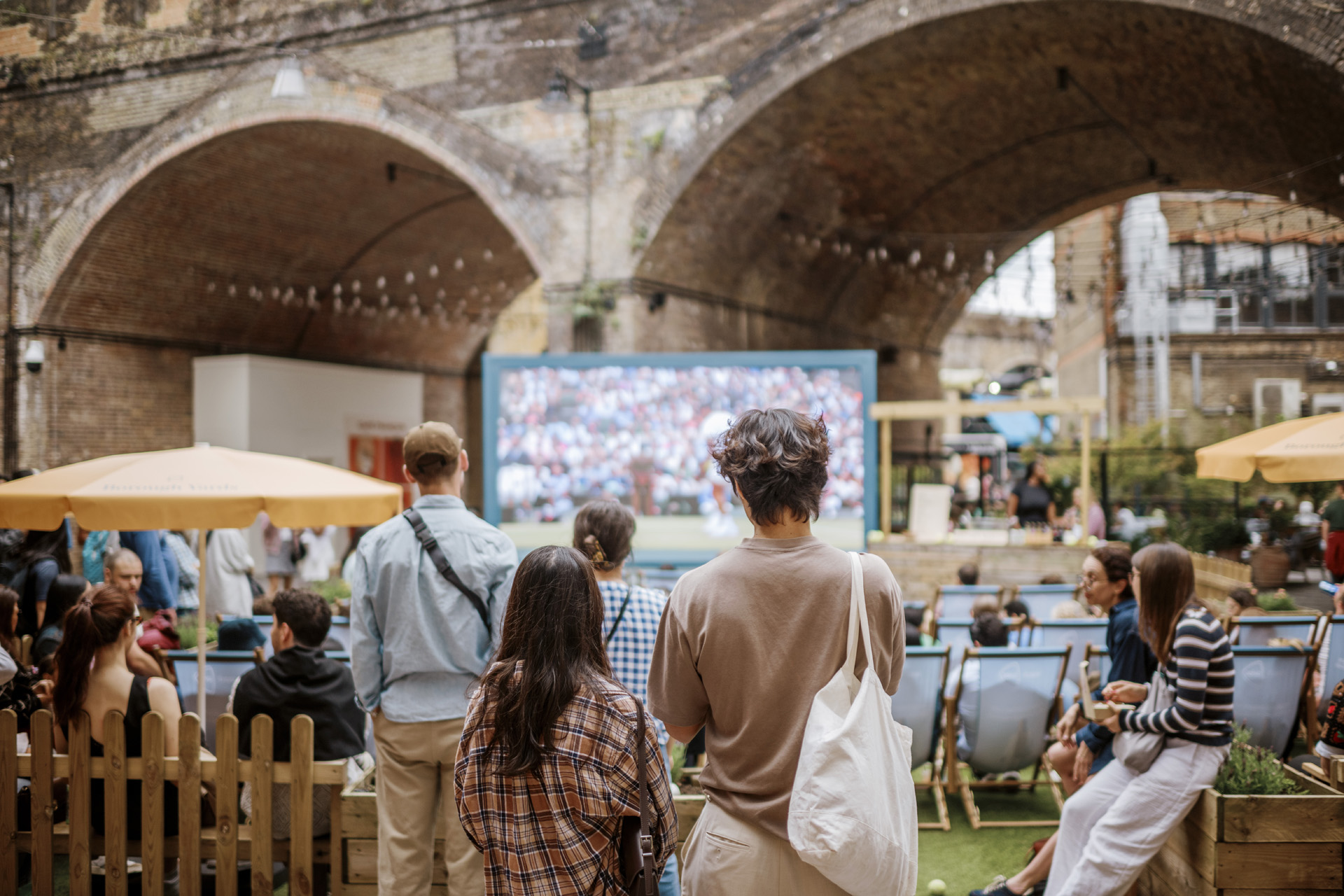 Two people watching a screen in Borough Yards, London